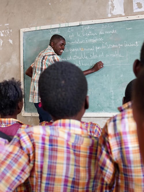 Man at a blackboard teaching children language arts